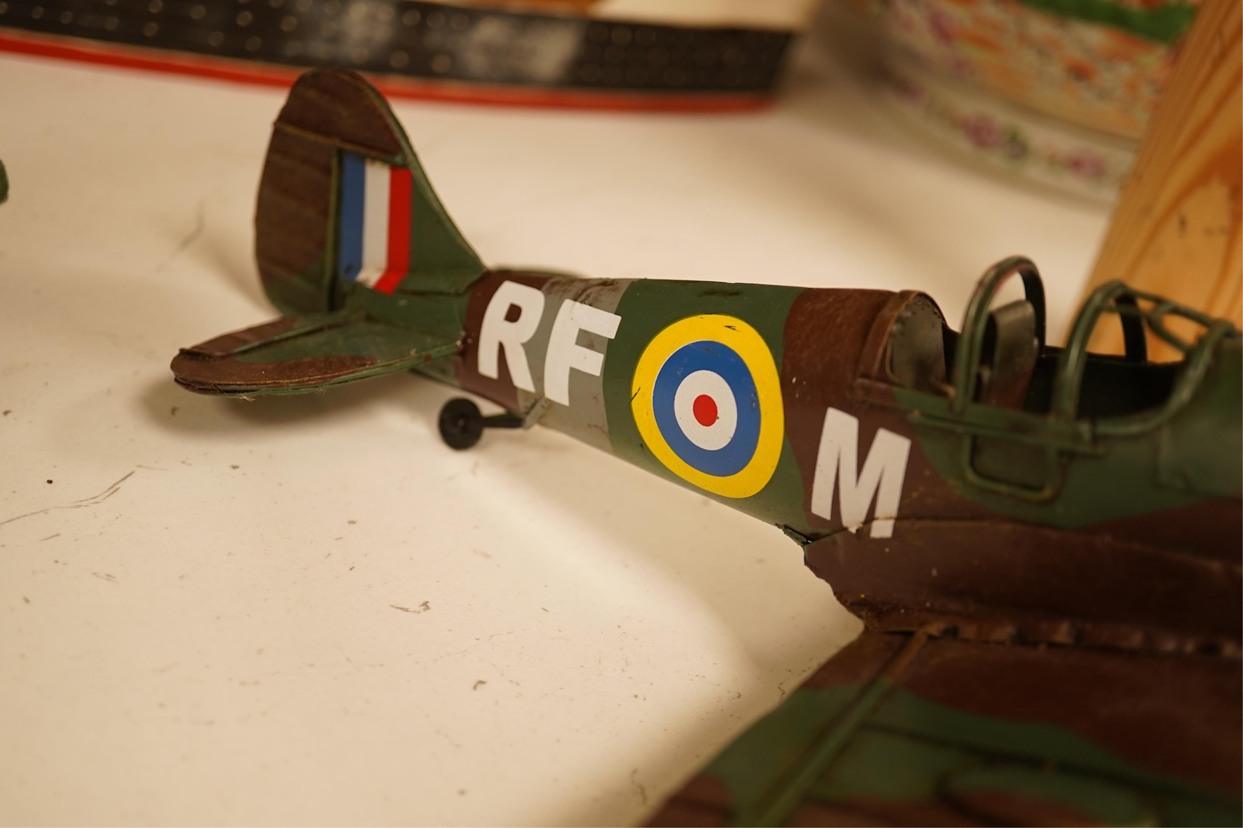 Five decorative metal models of military aircraft, including two Supermarine Spitfires, two First World War, British bi-planes, a German Albatros D.III bi-plane, and a wooden model of RMS Queen Mary, hull 77cm long